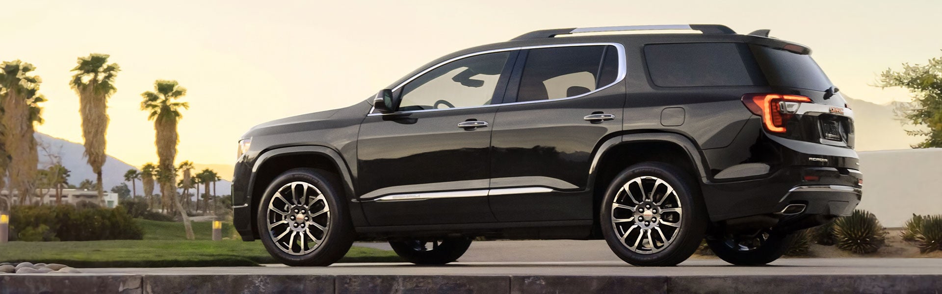 black GMC ACADIA on the road