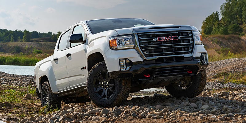 white GMC CANYON in mountain road