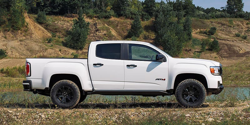 white GMC CANYON in farm road