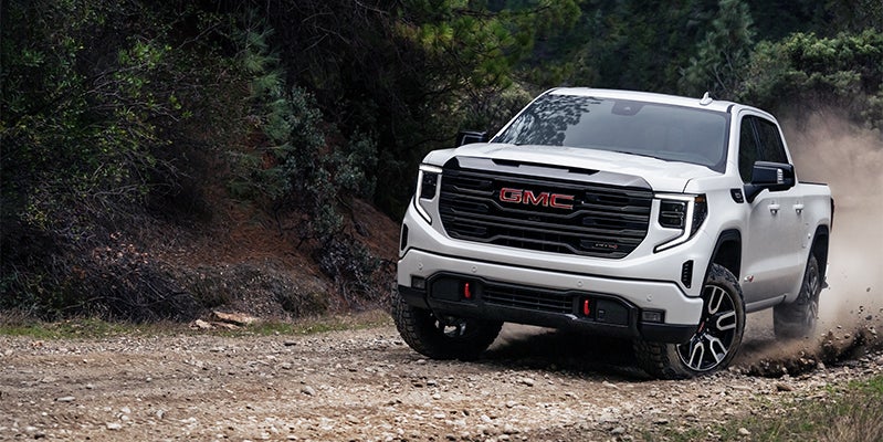 white GMC SIERRA 1500 mountain road